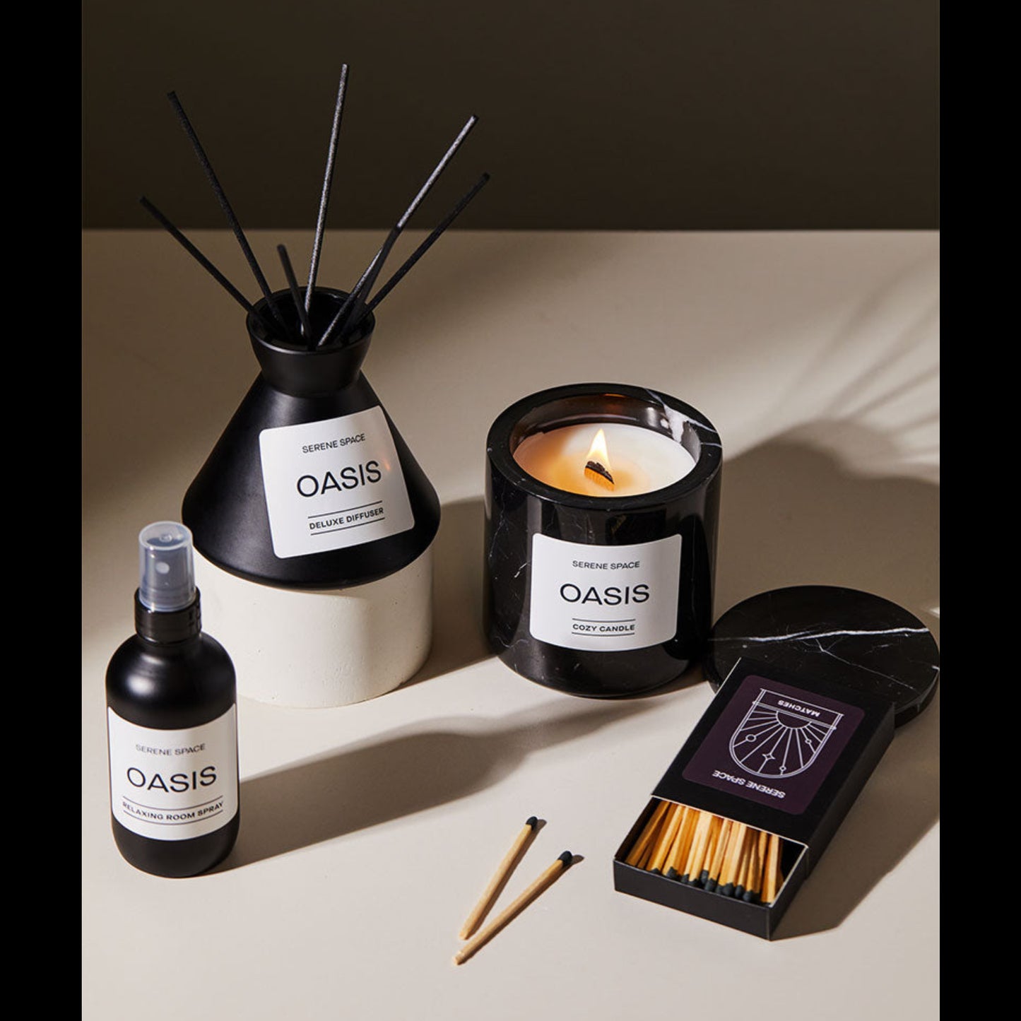 Oasis diffuser, candle, spray bottle, matches on a neutral background