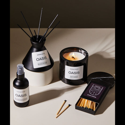 Oasis diffuser, candle, spray bottle, matches on a neutral background